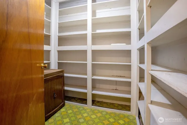 a view of a white house next to a yard