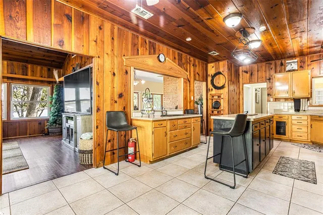a kitchen with stainless steel appliances granite countertop a sink a stove and a wooden cabinets