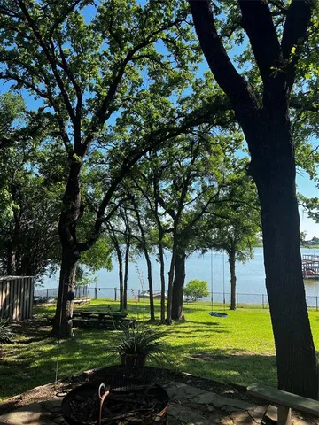 a view of a backyard with large trees