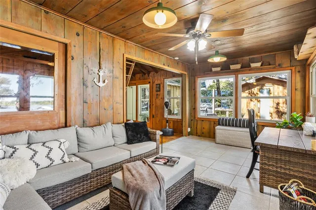 a living room with patio furniture and a chandelier