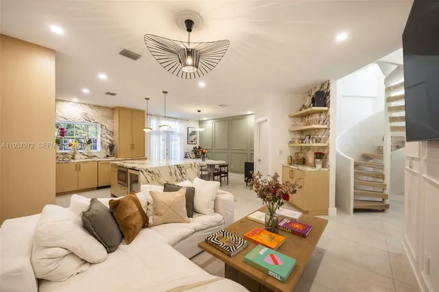 a spacious bedroom with a bed and a chandelier