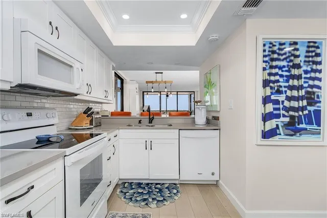a kitchen with a white cabinets and sink