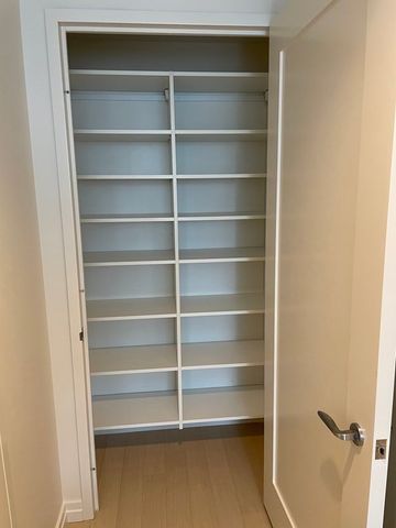 a view of walk in closet with empty racks