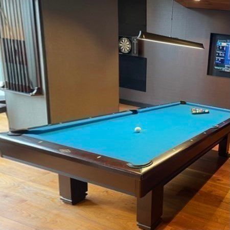a room with pool table and a mirror