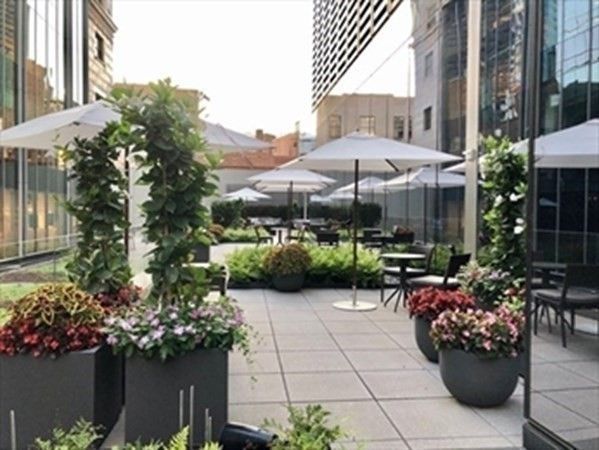 a view of a patio with furniture and flowers