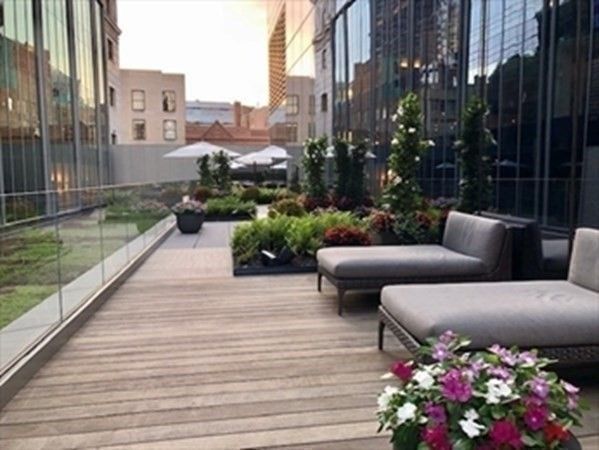 a view of a patio with couches and potted plants