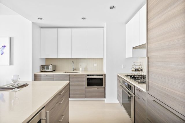 a kitchen with stainless steel appliances granite countertop a stove and a sink
