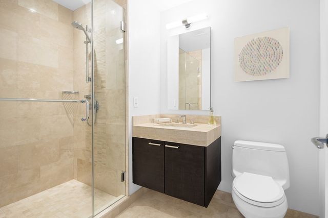 a bathroom with a toilet sink vanity and mirror