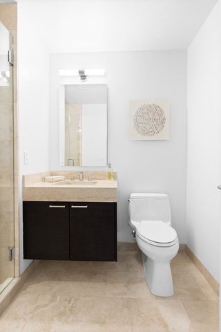 a bathroom with a sink vanity and a toilet