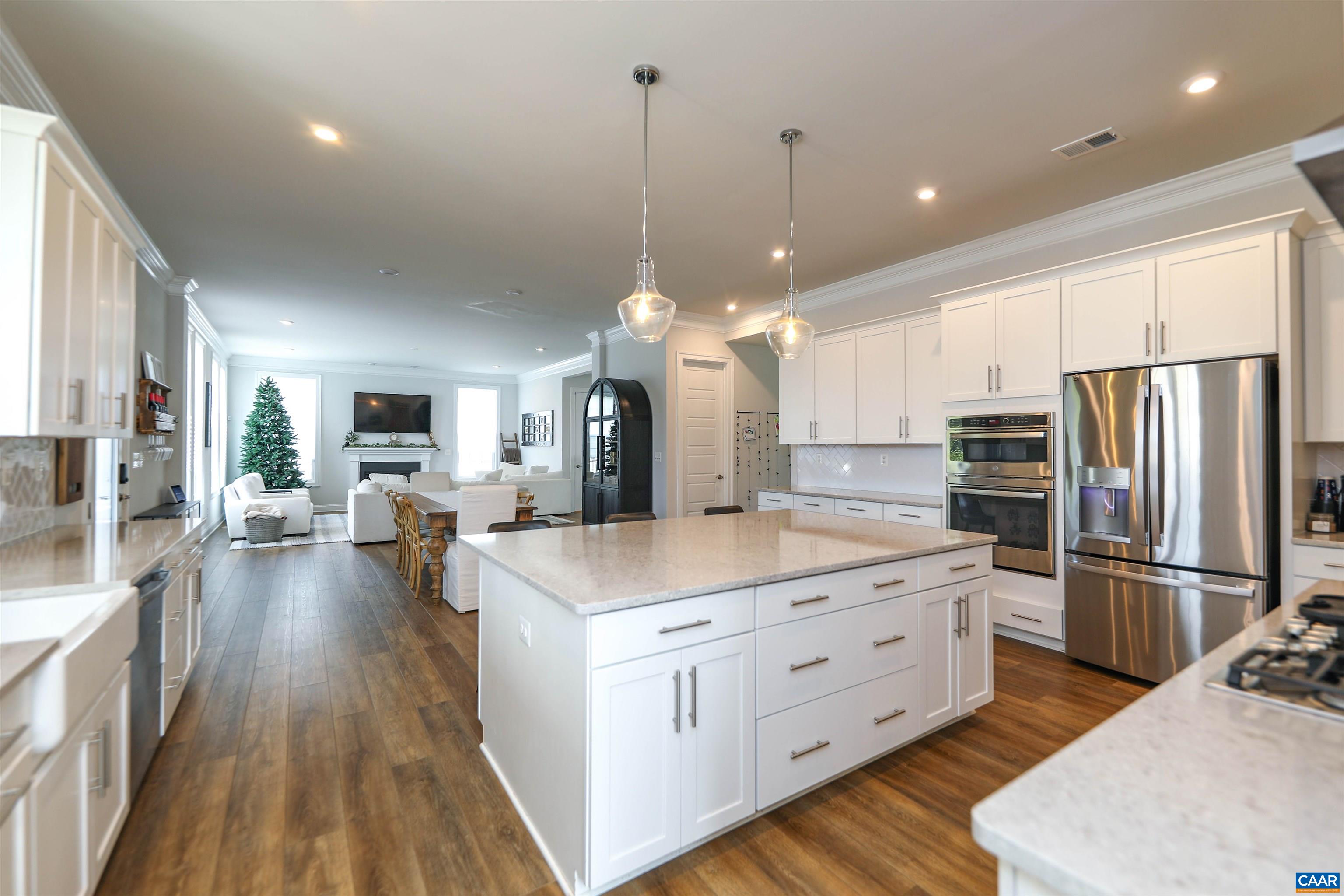 2483 Ferndown Lane Keswick, VA 22947 - Photo 12 of 54 a large kitchen with kitchen island white cabinets and stainless steel appliances