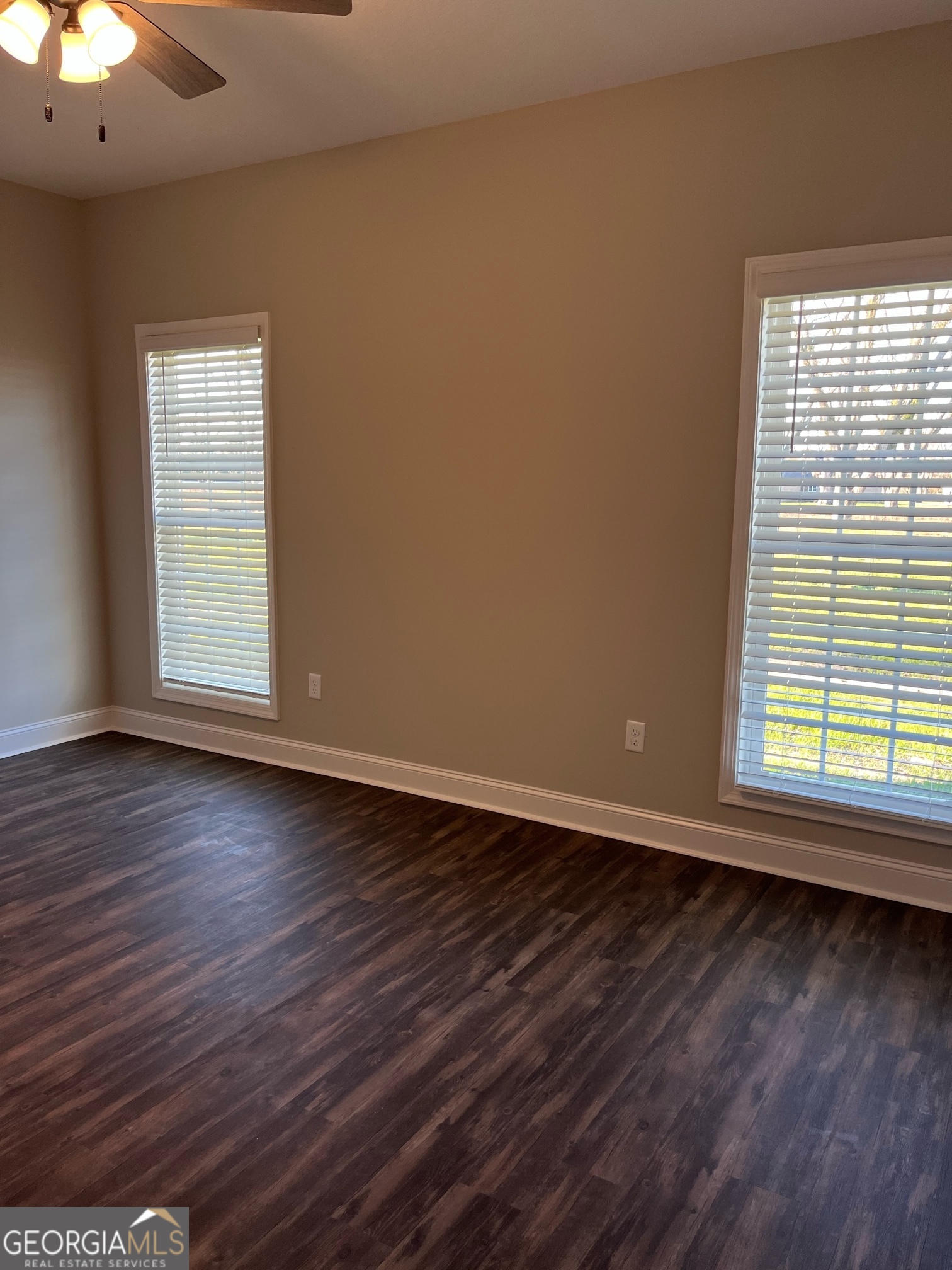 127 Orchard Way Brooklet, GA 30415 - Photo 9 of 15 an empty room with wooden floor and windows