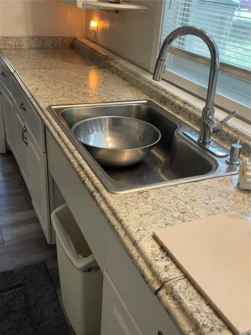 a room with wooden floor and a window