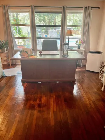 a bedroom with a bed a dresser and a window