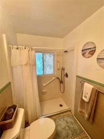 a view of a yard with wooden fence