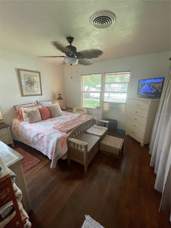 578 3rd Street Daytona Beach, FL 32117 - Photo 44 of 88 a bedroom with a bed and a chandelier