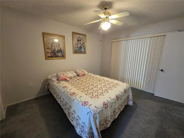 a bedroom with bed and a chandelier