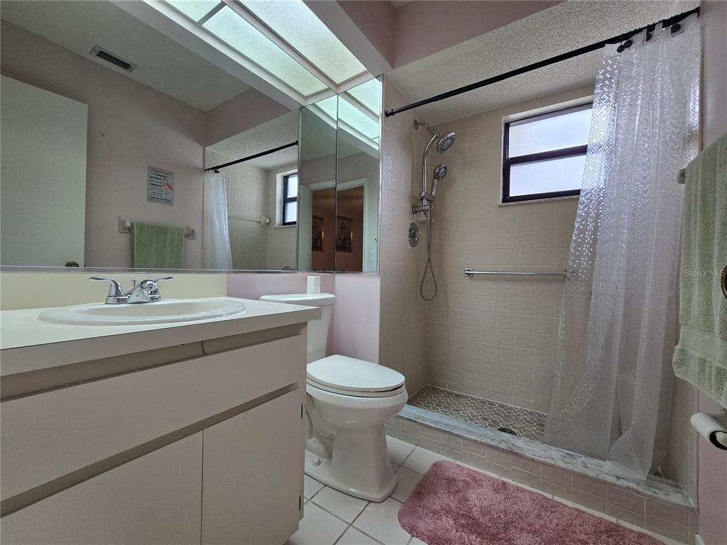 8055 Picketts Court, Unit 8055 Weeki Wachee, FL 34613 - Photo 14 of 22 a bathroom with a sink toilet and shower