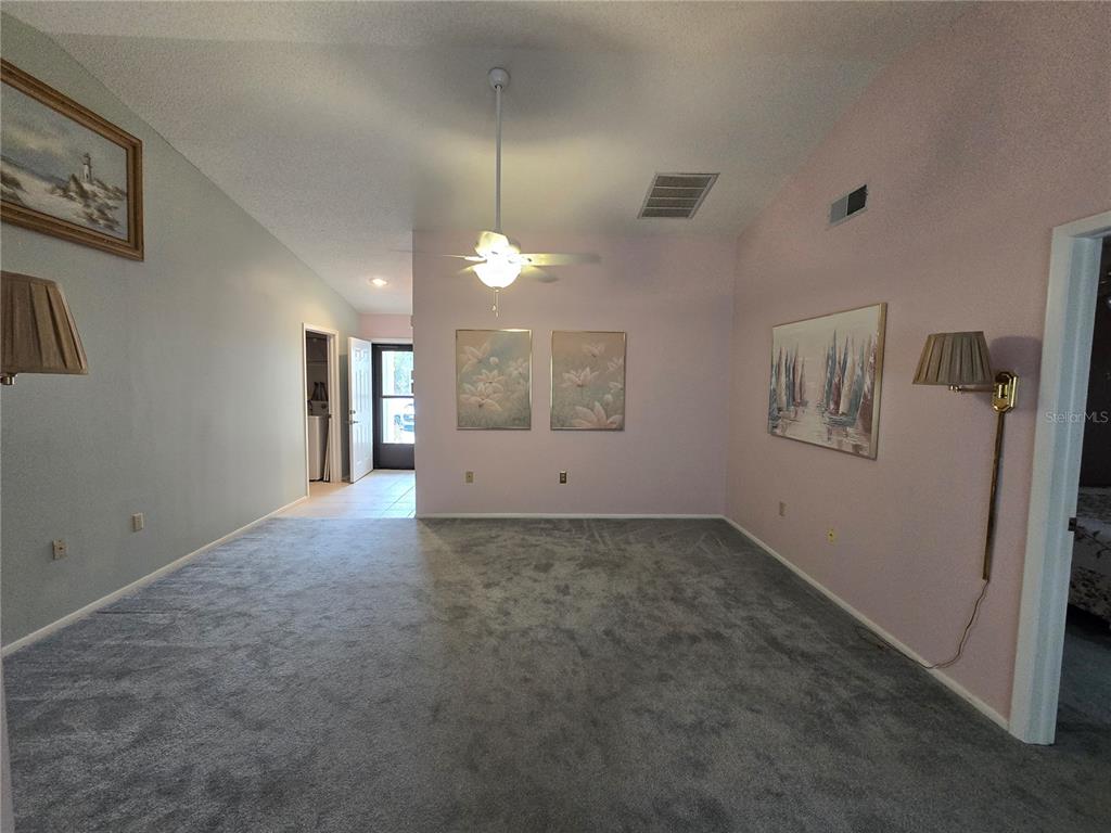 8055 Picketts Court, Unit 8055 Weeki Wachee, FL 34613 - Photo 2 of 22 en empty room with windows and fan