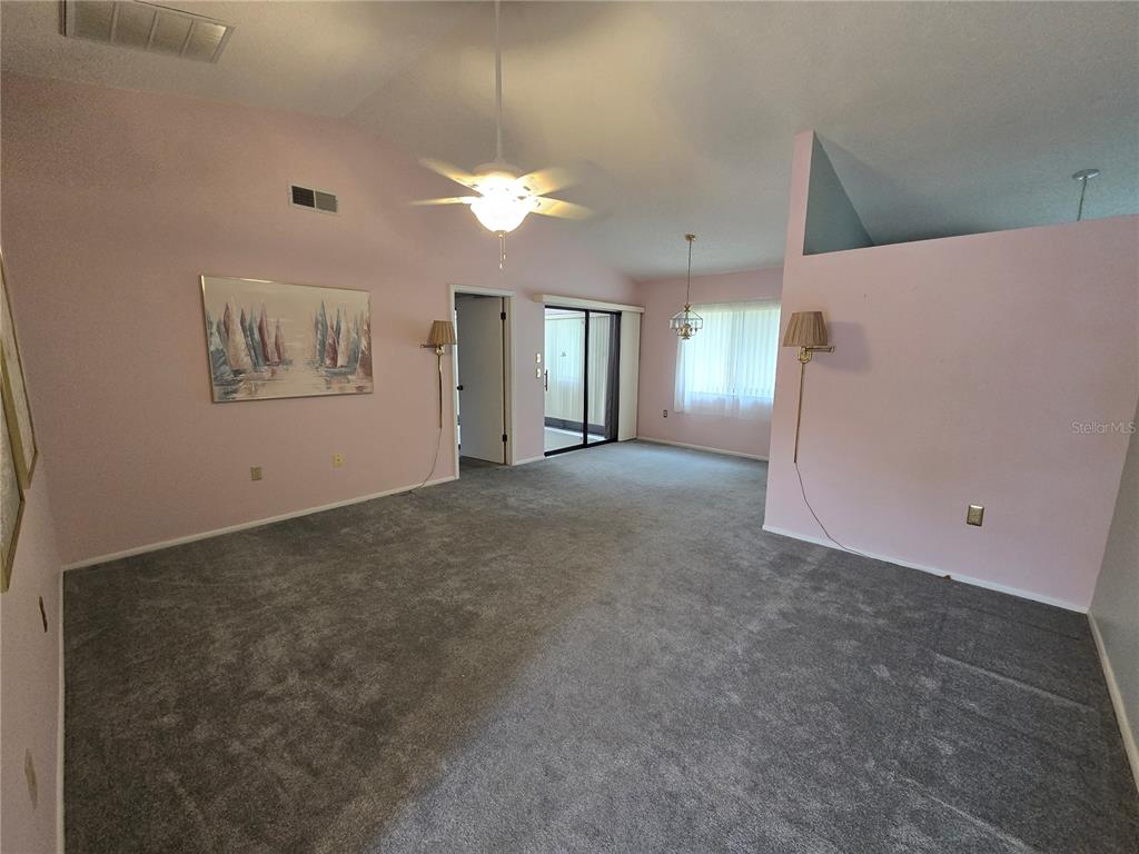 8055 Picketts Court, Unit 8055 Weeki Wachee, FL 34613 - Photo 5 of 22 an empty room with a ceiling fan and window