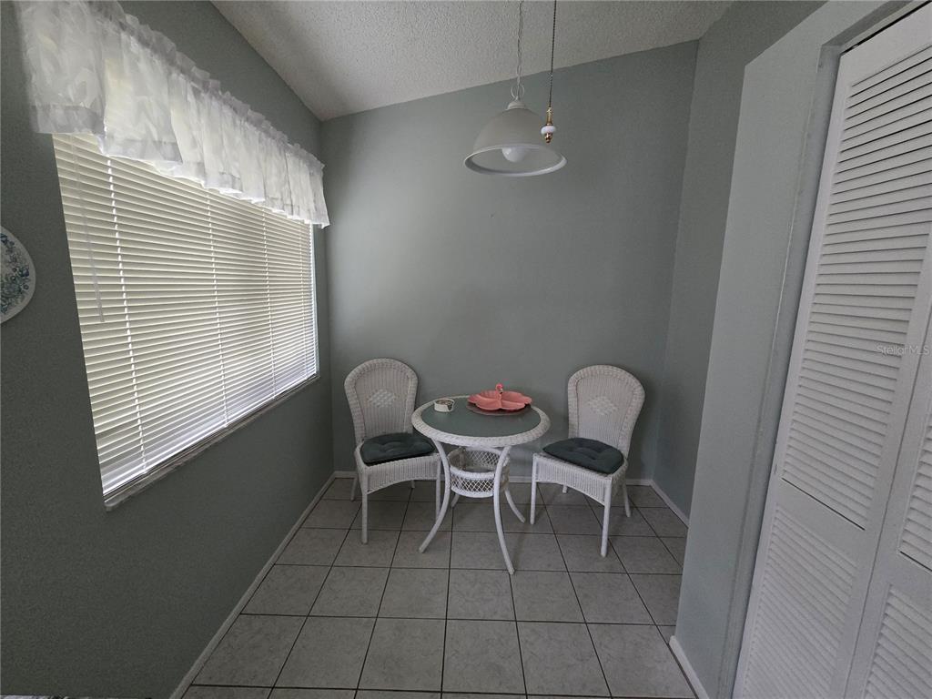 8055 Picketts Court, Unit 8055 Weeki Wachee, FL 34613 - Photo 10 of 22 a dining room with furniture and window