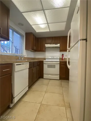 a kitchen with cabinets and stainless steel appliances