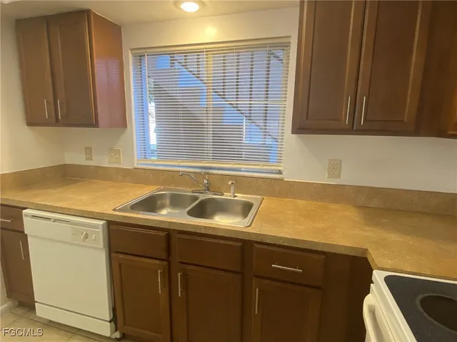 a sink a cabinets and window