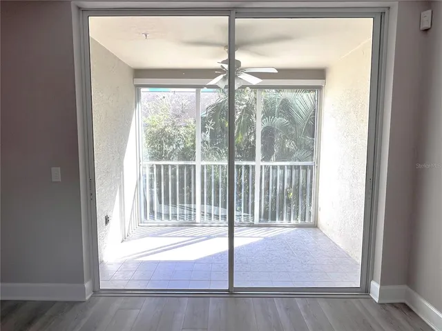 a view of a livingroom with wooden floor and staircase