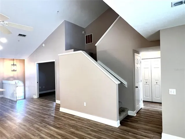 an empty room with windows and closet