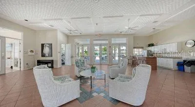 a living room with furniture and a dining table with kitchen view