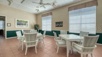 a view of a tennis ground with large trees