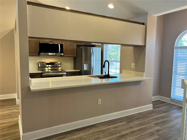 a kitchen with a stove and a microwave