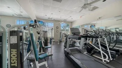 a view of swimming pool with large trees and a big yard with a white house