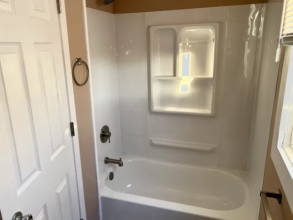 a bathroom with bathtub and shower