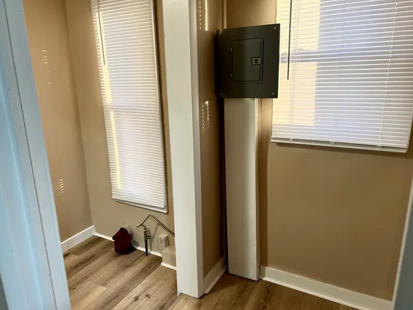 a view of walk in closet with wooden floor