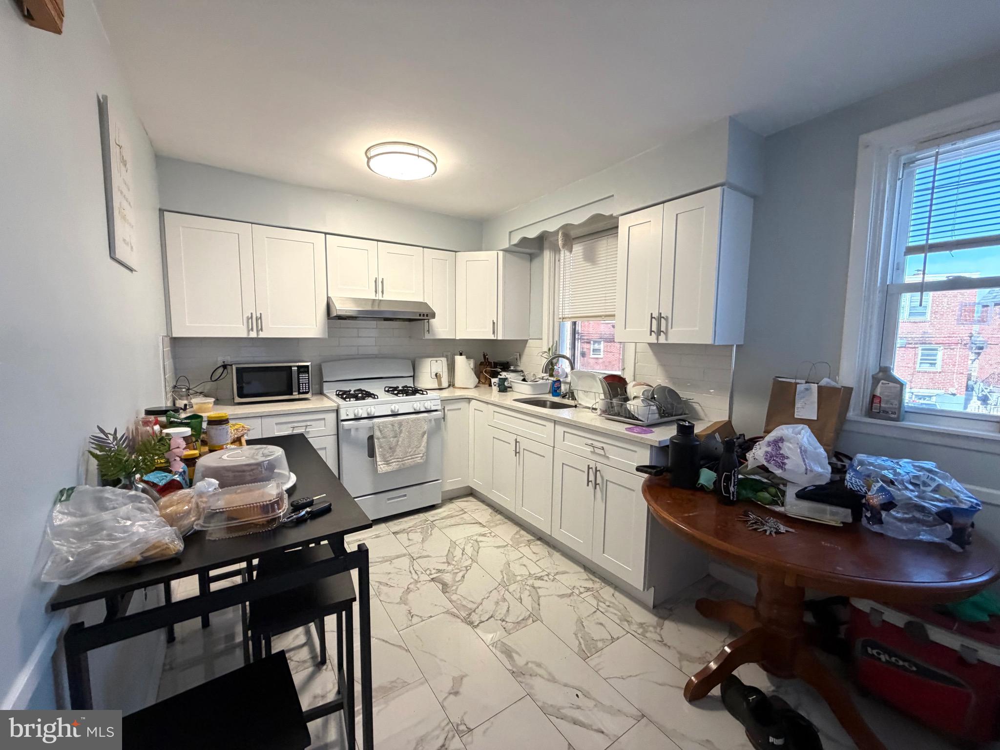 2019 Faunce Street Philadelphia, PA 19152 - Photo 4 of 10 a kitchen with a sink stove and cabinets