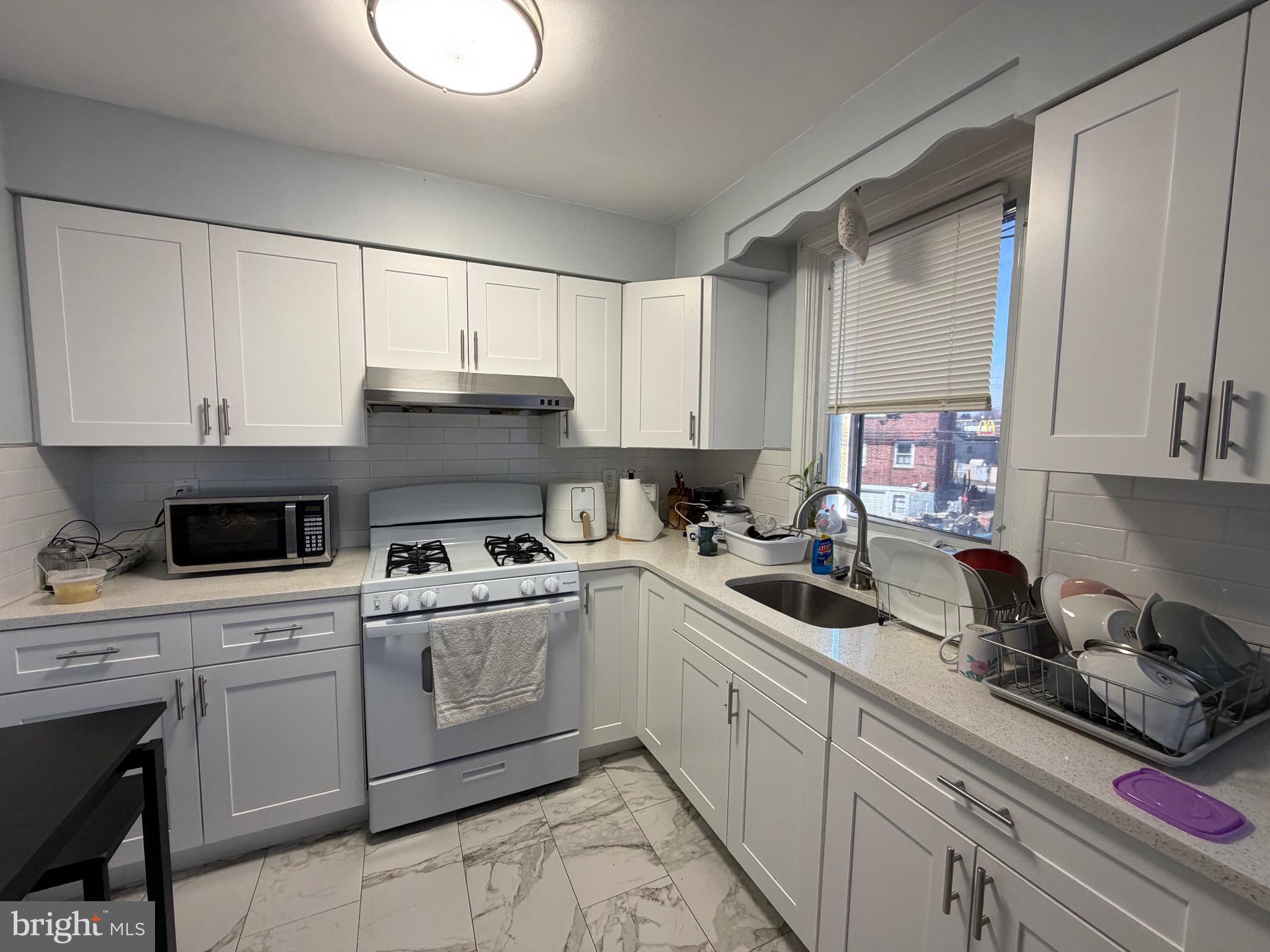2019 Faunce Street Philadelphia, PA 19152 - Photo 5 of 10 a kitchen with cabinets a sink and appliances