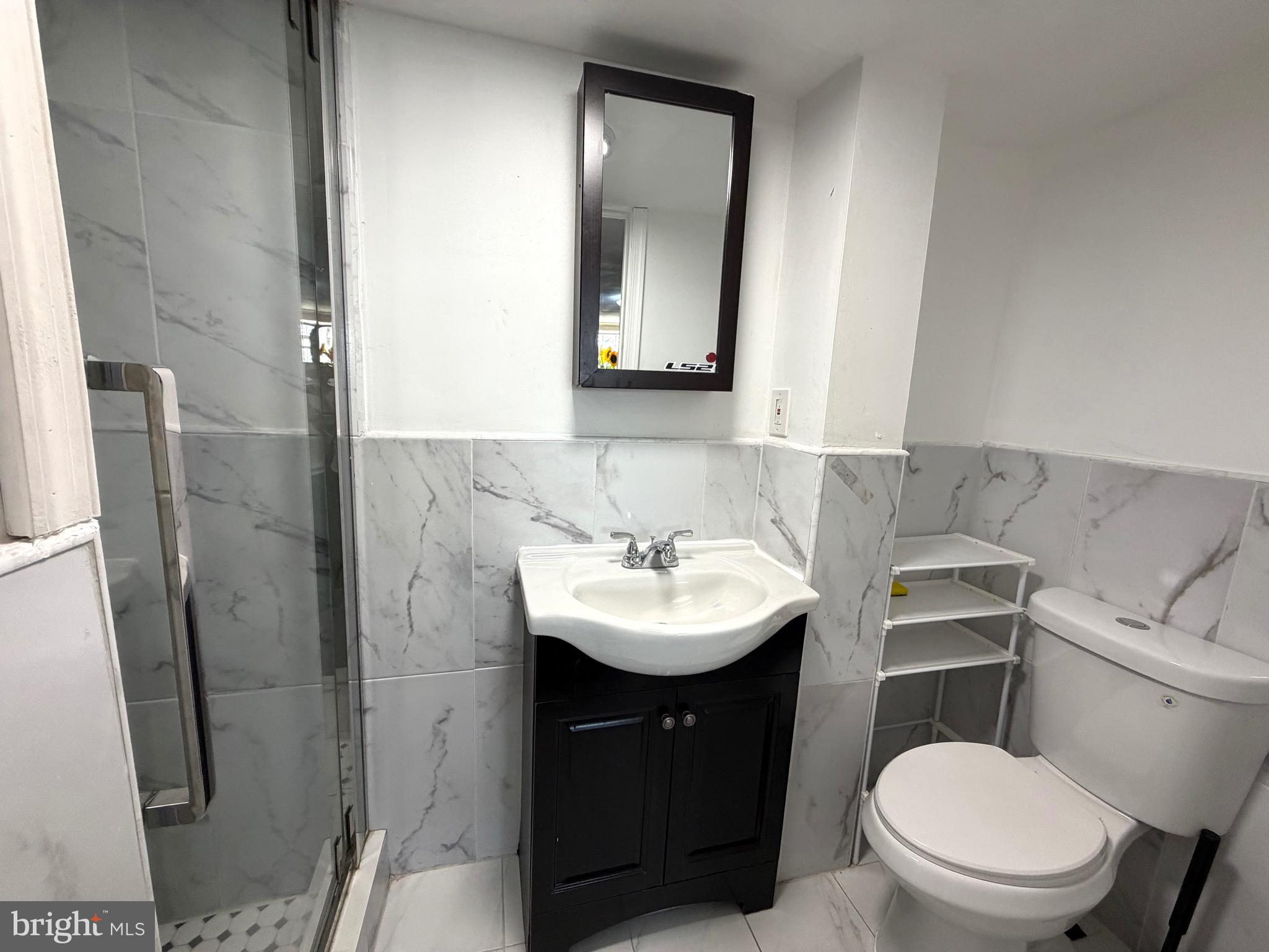 2019 Faunce Street Philadelphia, PA 19152 - Photo 9 of 10 a bathroom with a sink toilet and mirror