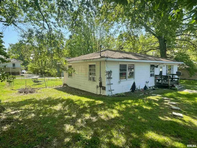 a view of a house with a yard porch and sitting area