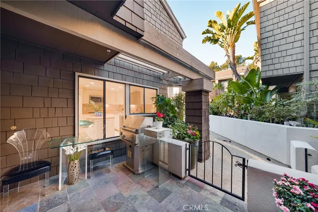 a view of a patio with table and chairs and potted plants