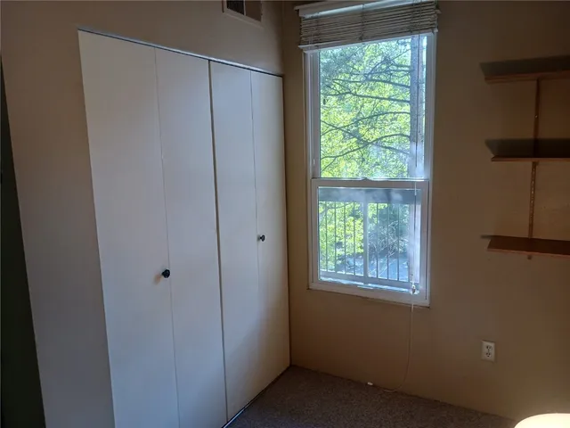a room with window and a bathroom with sink