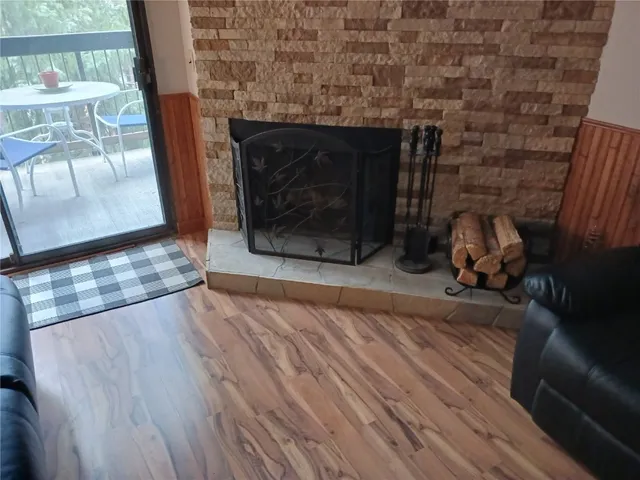 a room with wooden floor and a fireplace