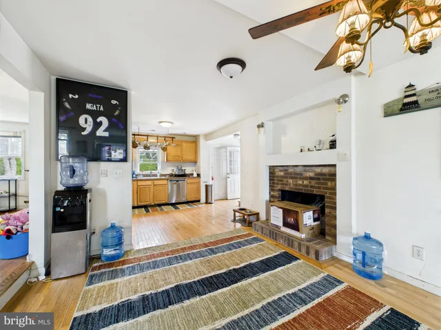 a kitchen with stainless steel appliances kitchen island granite countertop a refrigerator and cabinets