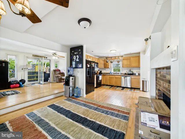 a kitchen with stainless steel appliances granite countertop a refrigerator a stove and a sink