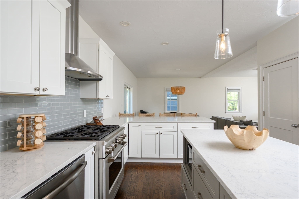 455 Broadway Hanover, MA 02339 - Photo 12 of 42 a kitchen with a sink a stove and cabinets