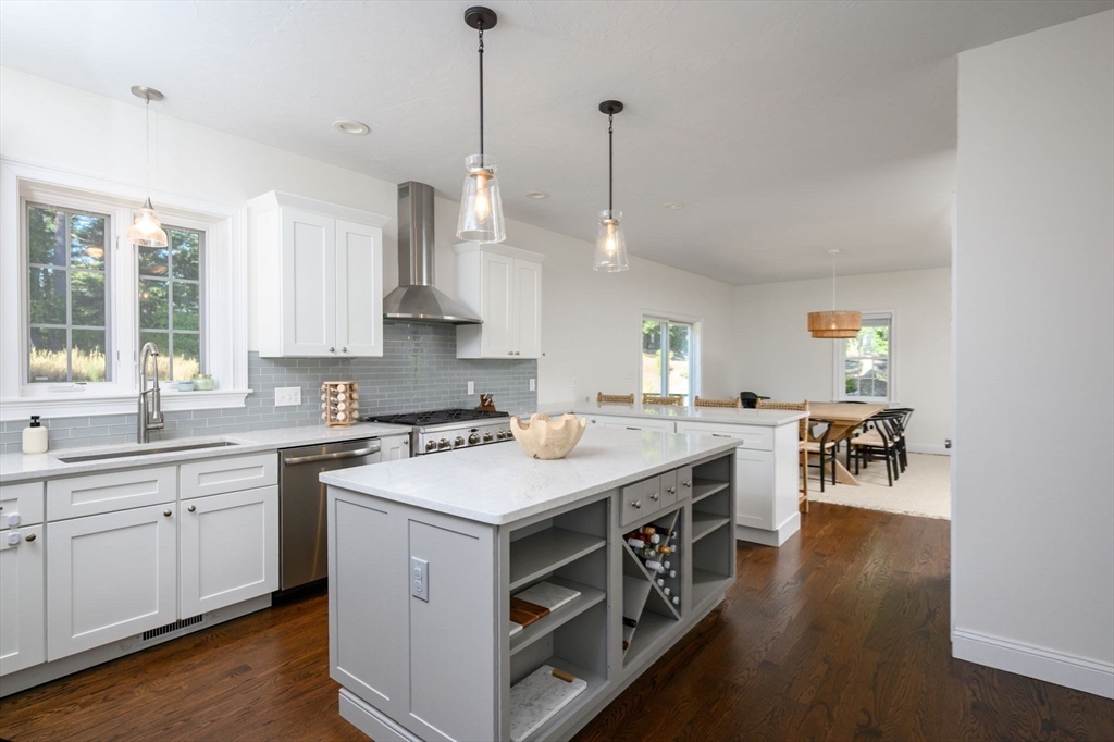 455 Broadway Hanover, MA 02339 - Photo 13 of 42 a kitchen with a stove and a wooden floor