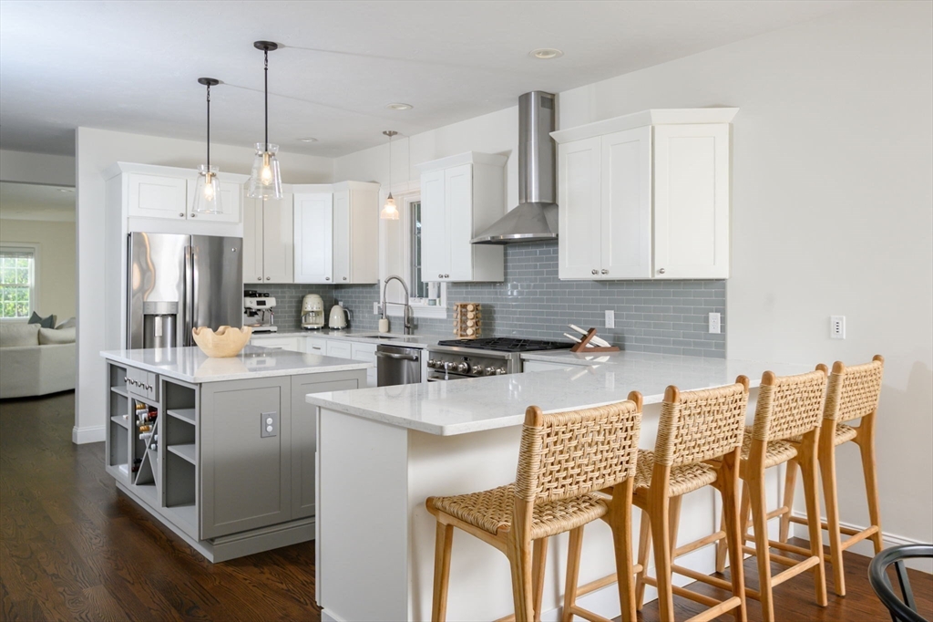 455 Broadway Hanover, MA 02339 - Photo 15 of 42 a kitchen with a table chairs refrigerator and cabinets