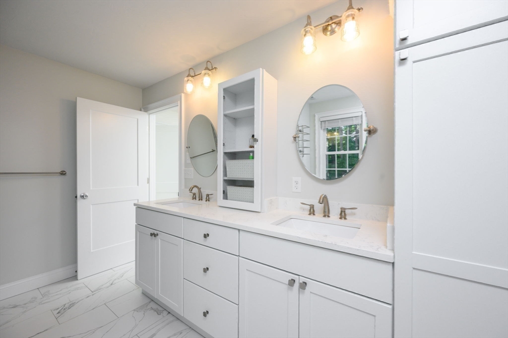 455 Broadway Hanover, MA 02339 - Photo 22 of 42 a bathroom with a double vanity sink and a mirror