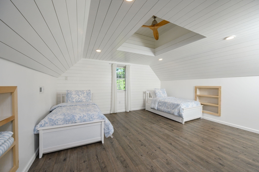 455 Broadway Hanover, MA 02339 - Photo 32 of 42 a bedroom with a bed and a chandelier