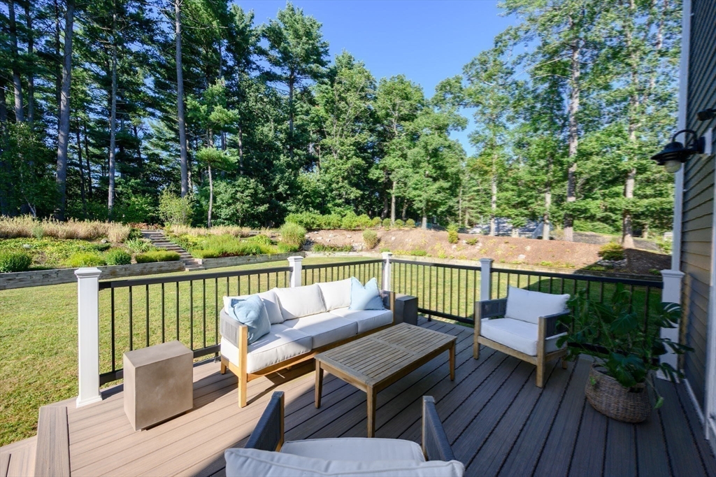 455 Broadway Hanover, MA 02339 - Photo 36 of 42 a view of a patio with wooden floor table and chairs