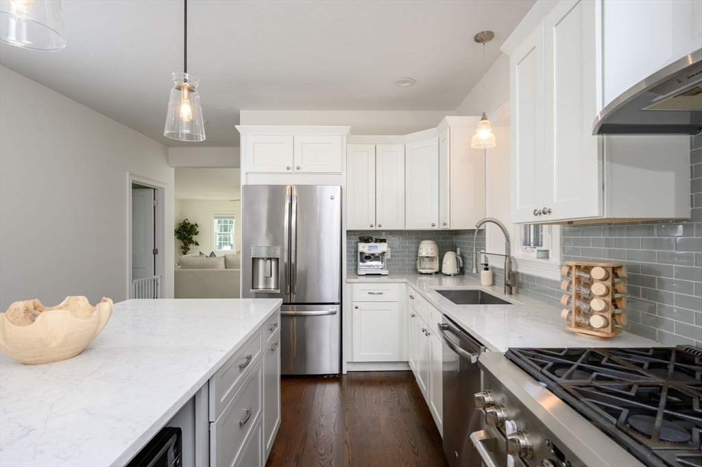 455 Broadway Hanover, MA 02339 - Photo 10 of 42 a kitchen with a sink a stove and refrigerator